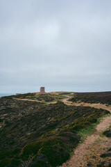 Fototapeta na wymiar Abandoned World War II bunker on the cliffs of the island on cloudy day
