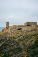 Abandoned World War II bunker on the cliffs of the island on cloudy day