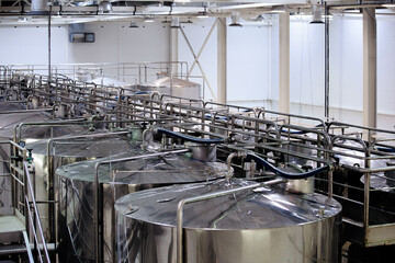 Modern winery production line. Storage vats and bottling equipment.