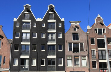 Amsterdam Nieuwezijds Voorburgwal Street House Facades with Different Gables and Blue Sky, Netherlands