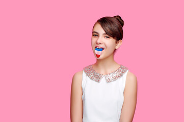 Brunette girl showing her tongue with a french flag on it