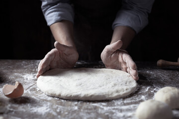 Chef man kneading dough bread or pizza for homemade cooking at table