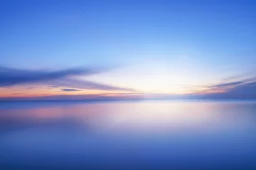 Poster Calm blue colored sea and clear sky at sunset © eshma