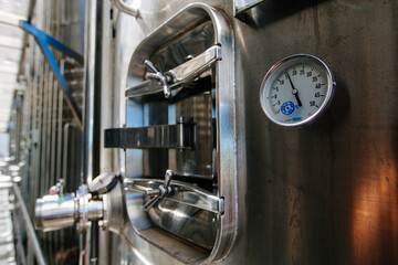 Thermometer or pressure gauge on fermentation vat in modern winery