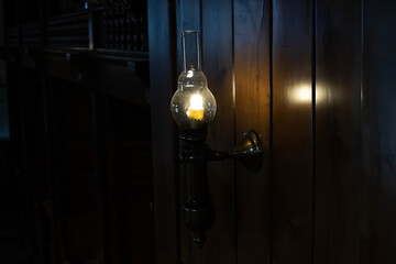 Retro-style lamp on the wall in the dark