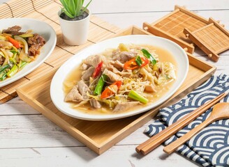 Fried large intestine with shredded ginger served in a dish isolated on wooden tray and napkin side view of taiwan food