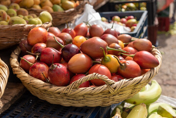 Basket of Tamarillo for sale at a farmers market in Colombia