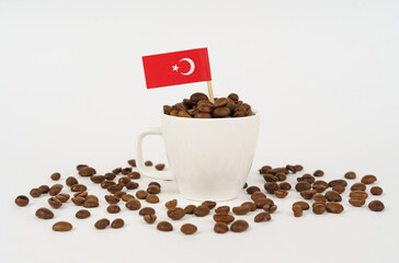 The Turkish flag sticks out of a cup of roasted coffee beans.
