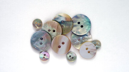 Buttons made of natural mother of pearl. On a white background.