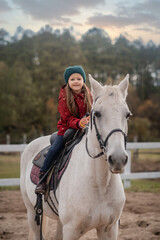 girl is  riding a white horse 