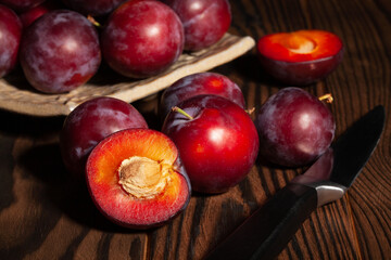 sliced plum group on wood background
