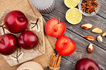 sliced plum group on wood background top view