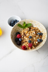 grains granola with nuts in white bowl breakfast food concept on marble surface
