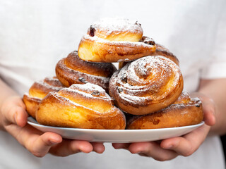 Gluten-free buns made of rice and corn flour with cinnamon, raisins and cranberries. The concept of proper nutrition, gluten-free diet, healthy home baking.