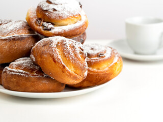 Gluten-free buns made of rice and corn flour with cinnamon, raisins and cranberries. The concept of proper nutrition, gluten-free diet, healthy home baking. On a light background.Healthy breakfast.