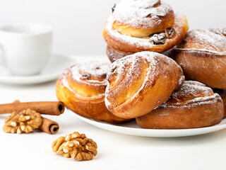 Gluten-free buns made of rice and corn flour with cinnamon, raisins and cranberries. The concept of proper nutrition, gluten-free diet, healthy home baking. On a light background.Healthy breakfast.
