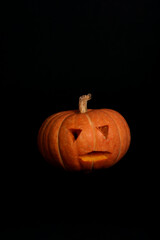 spooky concept - jack-o-lantern isolated on black background. Image contains copy space