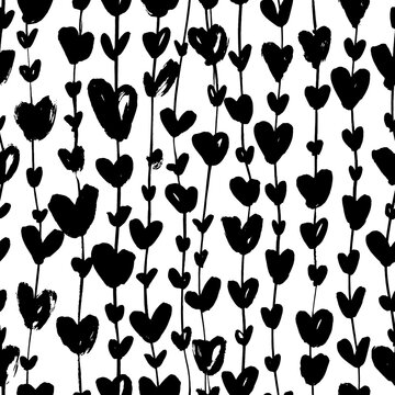 Black silhouettes heart ivy seamless pattern. Brush drawn liana or garland with heart symbols. Thin long vertical branches with leaves ornament. Vector ink illustration for wedding and love holidays. 