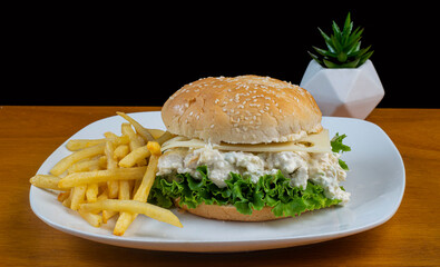 chicken salad on a bulkie roll with  french fries,