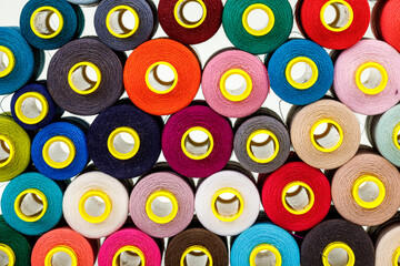 set of multi-colored spools of thread for sewing