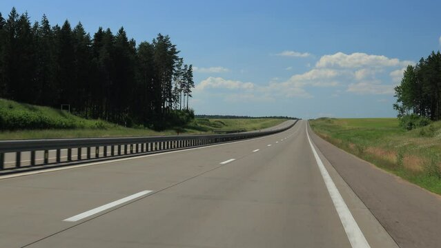 Road view on a summer day. Highways and cars, roadside and white road line markings.