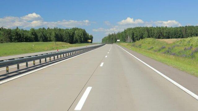 Road view on a summer day. Highways and cars, roadside and white road line markings.