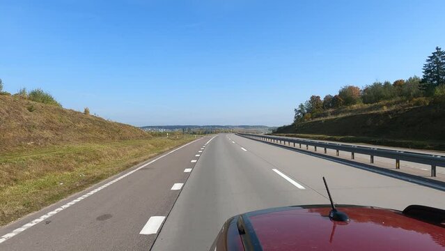 Road view on a summer day. Highways and cars, roadside and white road line markings.