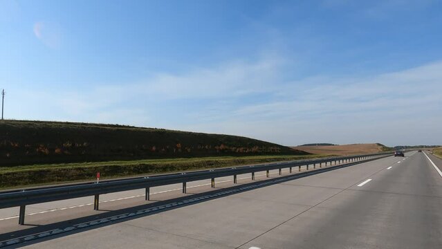 Road view on a summer day. Highways and cars, roadside and white road line markings.