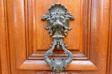 European Vintage old metal wrought iron door knocker. Design detail. Paris.
