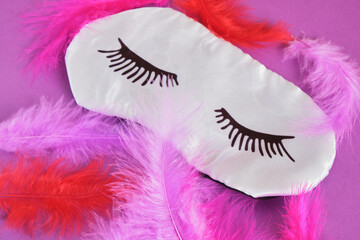 Top view silk sleeping mask and feathers copyspace
