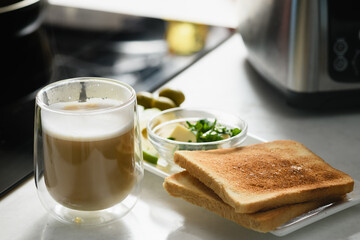 Two toast with sliced avocado, butter, cheese for a healthy sandwich. Close-up.