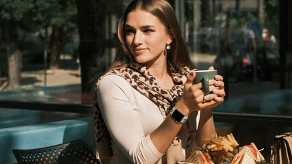 Girl drink tea and waits friends