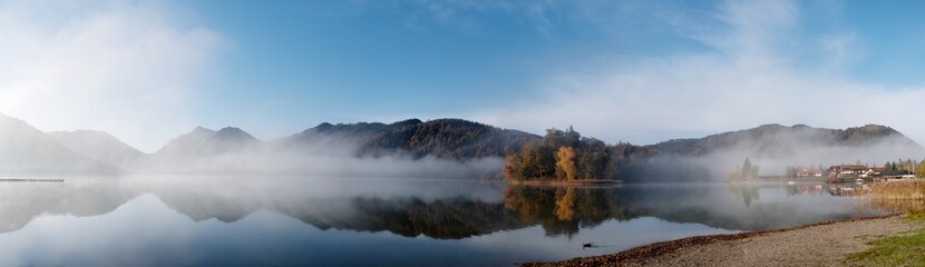Autumn morning fog on the lake. Panorama.