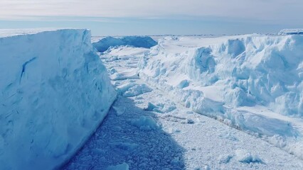 Frozen south pole. Desert white land of snow and ice drone shot. Snow covered antarctic surface aerial view flight. 
