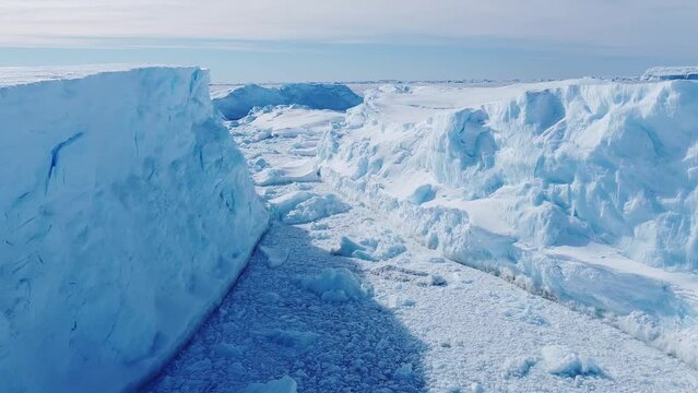 Frozen south pole. Desert white land of snow and ice drone shot. Snow covered antarctic surface aerial view flight. 