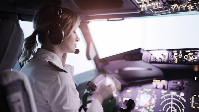 Woman pilot in the cockpit preparing for takeoff 