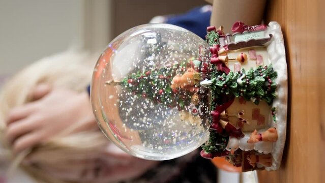 Christmas snow globe, unfocused boy writing letter to Santa Clause.