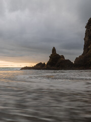 Flowing ocean water on the coast of Piha Beach, Auckland, New Zealand.