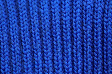 blue dark woolen texture of a sweater fabric with a pattern