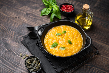 Risotto with pumpkin and pumpkin seeds, parmesan cheese and basil.  risotto alla milanese with saffron. italian cuisine seasonal fall menu