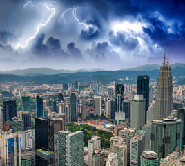 Aerial view of Kuala Lumpur city center skyline during a thunderstorm