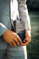 hands of a person with book of mormon - obrazy, fototapety, plakaty
