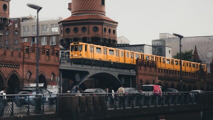 Fototapeta premium Scenic view of a U-Bahn train driving on a subway bridge in Berlin, Germany