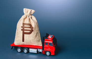 Truck with a philippine peso money bag. Loan or deposit. Financial aid, investments and subsidies....