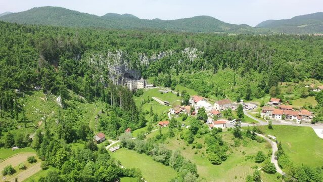 Predjama Castle - Postojna Cave Park Slovenia castle hidden in a cave rock Aerial shot drone 4k full hd landscape view europe historical 