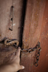 Hand reaching for a handle of a door