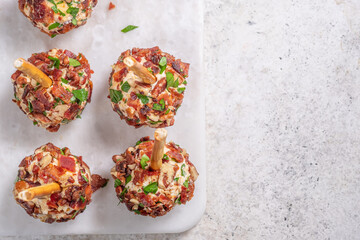 Christmas cheese ball appetizers with bacon, pecans and herbs.