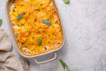 Savory Sweet potato gratin with cream and cheddar cheese in baking dish