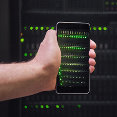 Mobile phone in the hands of a man at the server for data storage, close-up