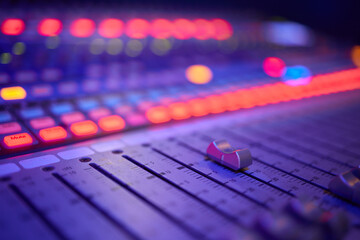 View of music mixer in concert, filled with lights.